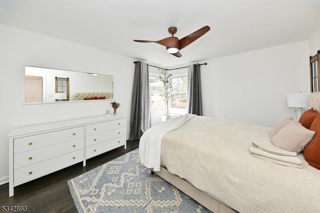 bedroom with dark wood-type flooring and a ceiling fan