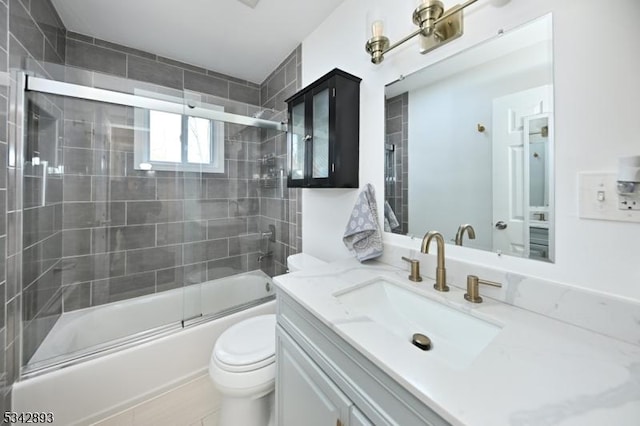 full bathroom featuring vanity, toilet, and combined bath / shower with glass door