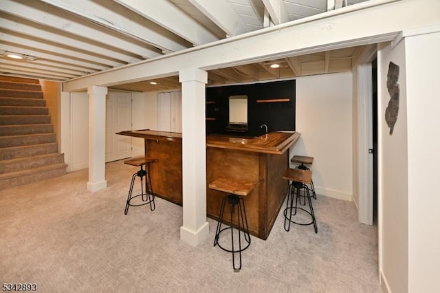 bar with stairs, baseboards, wet bar, and carpet flooring