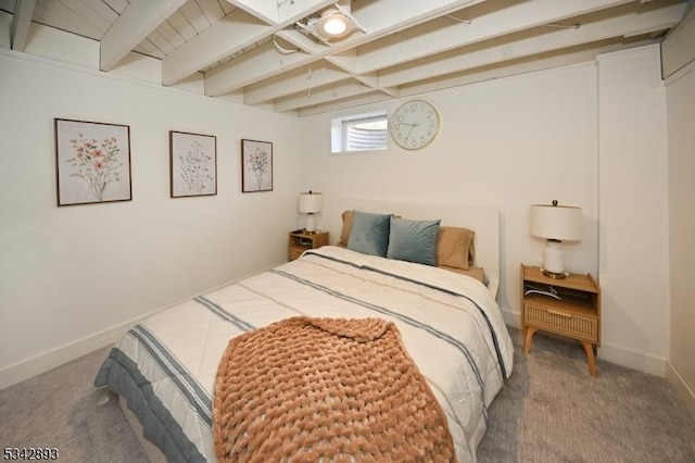 carpeted bedroom with beamed ceiling and baseboards