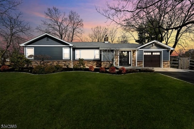 single story home with fence, driveway, an attached garage, stone siding, and a lawn