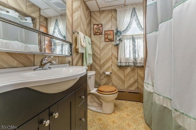 bathroom with a baseboard radiator, toilet, visible vents, and vanity