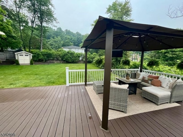 deck featuring a shed, a yard, an outdoor structure, a gazebo, and outdoor lounge area