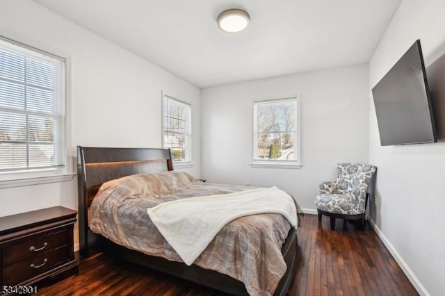 bedroom featuring baseboards and dark wood finished floors