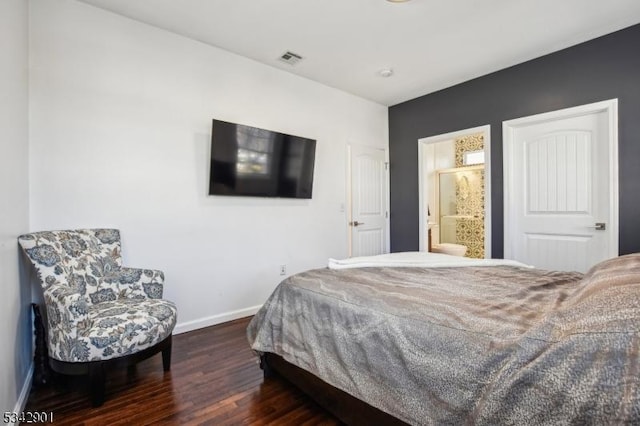 bedroom featuring connected bathroom, wood finished floors, visible vents, and baseboards