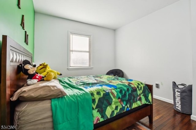 bedroom with baseboards and wood finished floors