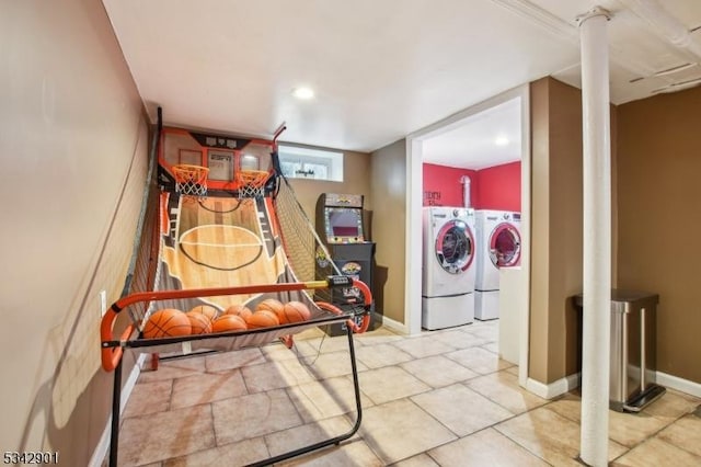 playroom featuring baseboards and washing machine and clothes dryer