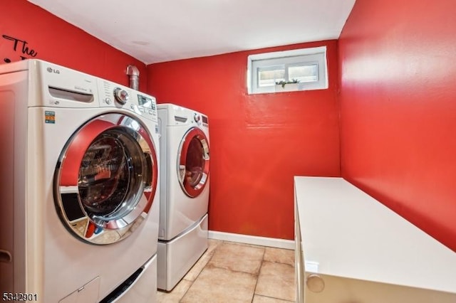 laundry area featuring tile patterned flooring, laundry area, and separate washer and dryer