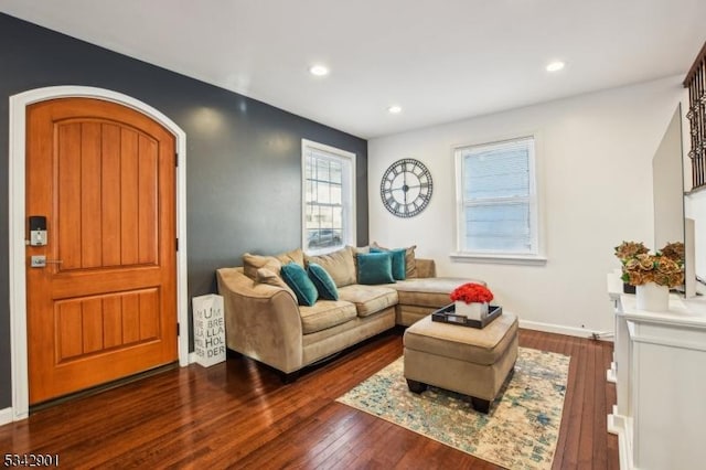 living area featuring recessed lighting, baseboards, wood-type flooring, and arched walkways