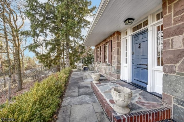 doorway to property featuring stone siding