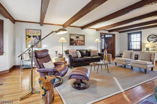 living room featuring beam ceiling, baseboards, and wood finished floors