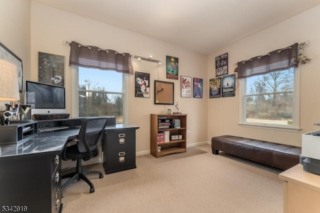 home office with light colored carpet and baseboards