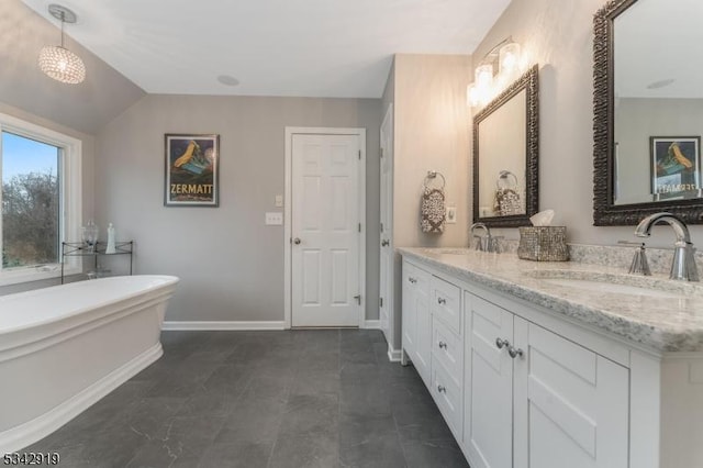 full bathroom featuring a sink, baseboards, a soaking tub, and double vanity