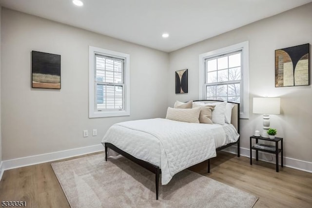 bedroom featuring recessed lighting, light wood-style floors, and baseboards