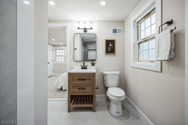 full bathroom with vanity, baseboards, visible vents, tile patterned floors, and toilet