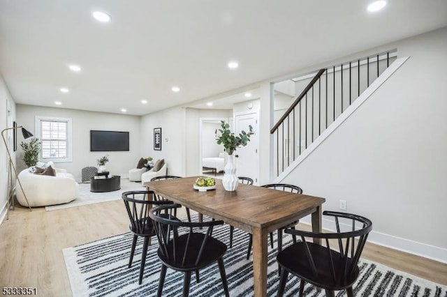 dining area featuring light wood finished floors, stairway, recessed lighting, and baseboards