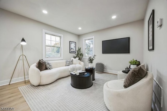 living room with visible vents, recessed lighting, baseboards, and wood finished floors