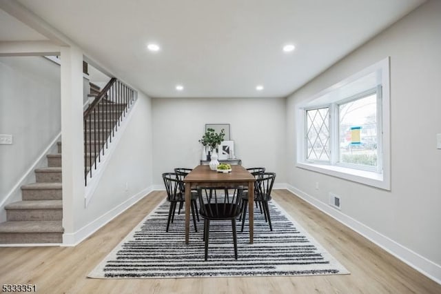 dining room with visible vents, baseboards, and wood finished floors