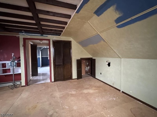 additional living space featuring lofted ceiling