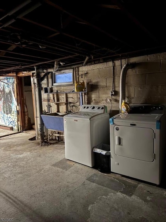 basement with washer and dryer and a sink