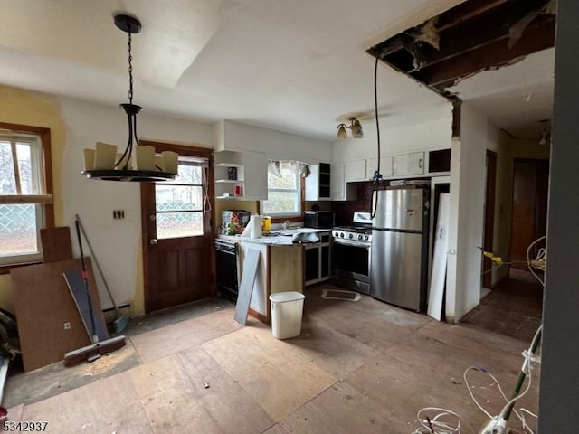 kitchen with decorative light fixtures, appliances with stainless steel finishes, and light countertops