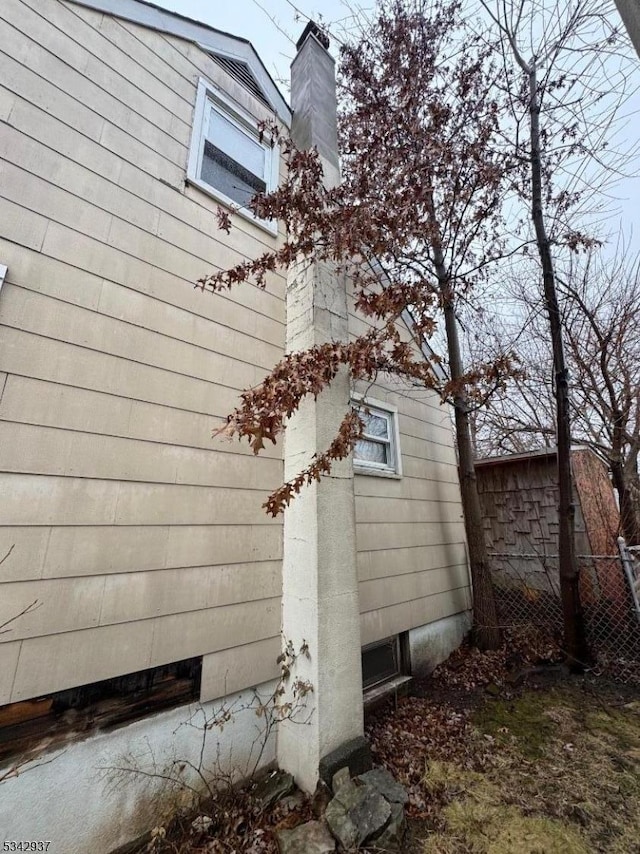 view of property exterior featuring a chimney