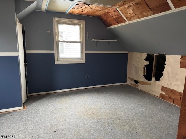 additional living space featuring lofted ceiling