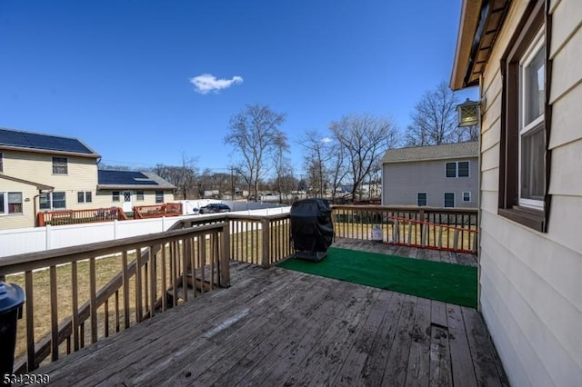 deck with a residential view and fence