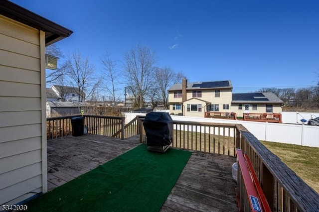 deck with a lawn, area for grilling, and fence