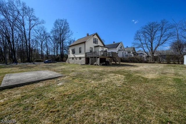 view of yard featuring stairs and a deck