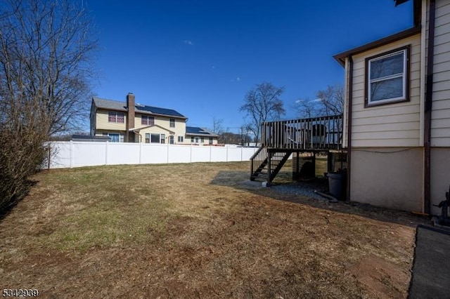 view of yard with stairs, a deck, and fence