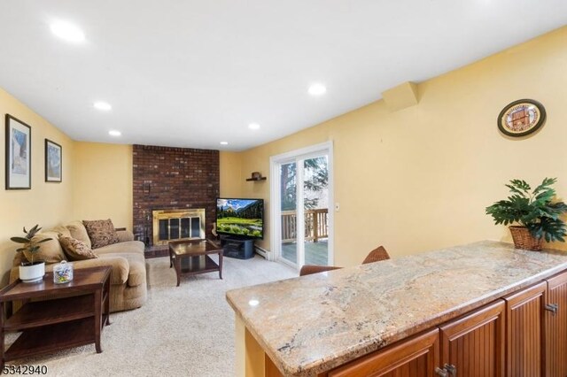 living area with recessed lighting, a fireplace, and light carpet