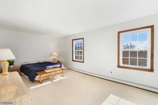 carpeted bedroom featuring a baseboard heating unit