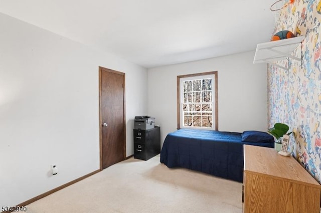 bedroom with light carpet and baseboards