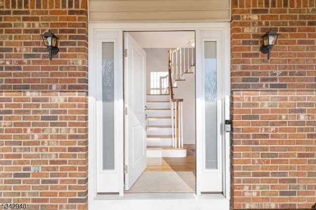 view of exterior entry with brick siding