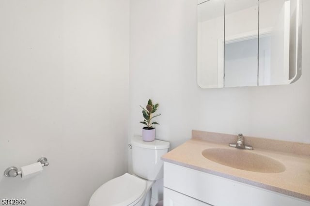 bathroom featuring toilet and vanity