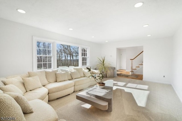 carpeted living area featuring recessed lighting, stairway, and baseboards