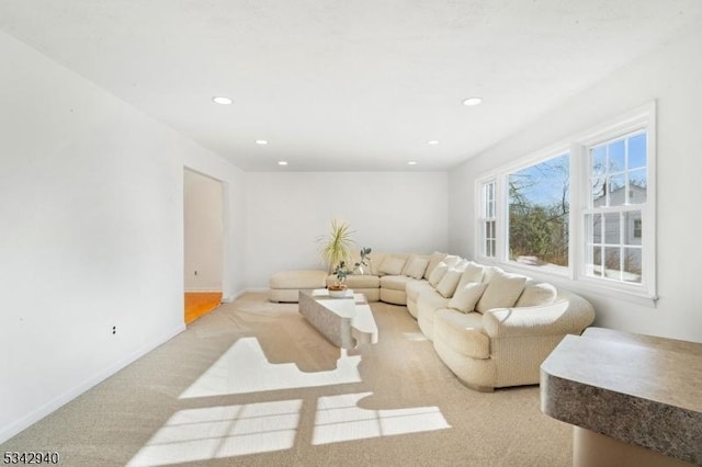 living room with light colored carpet, recessed lighting, and baseboards