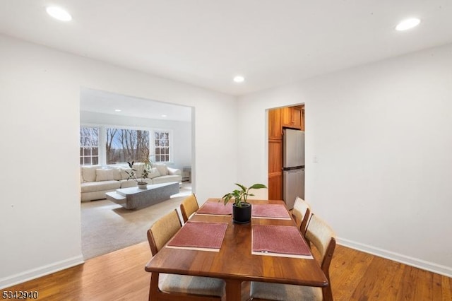 dining room featuring recessed lighting, light wood-style floors, and baseboards