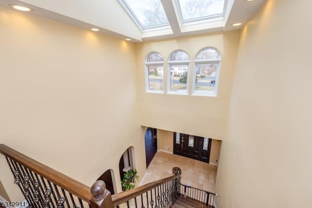 stairs with recessed lighting and a skylight