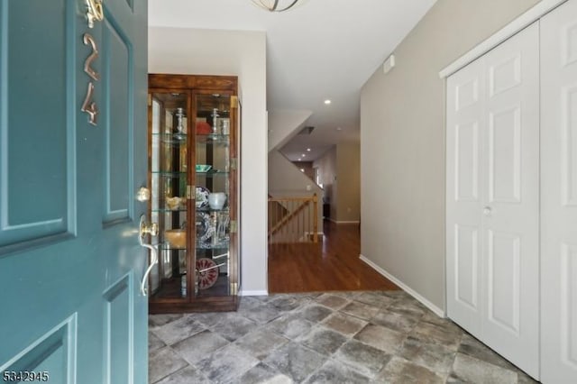 foyer featuring baseboards