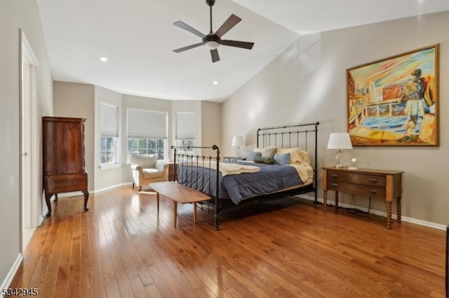 bedroom featuring lofted ceiling, recessed lighting, wood-type flooring, baseboards, and ceiling fan