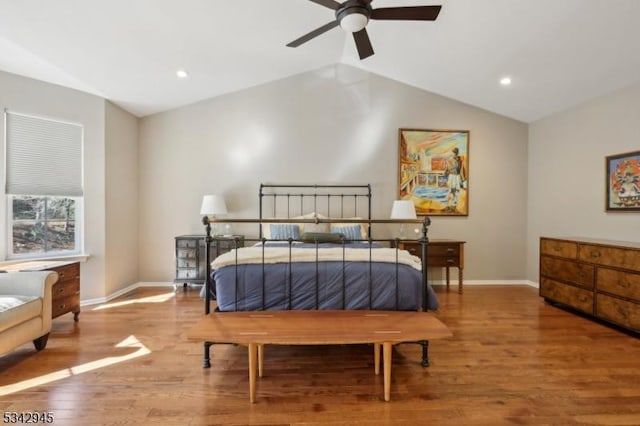 bedroom with vaulted ceiling, recessed lighting, wood finished floors, and baseboards