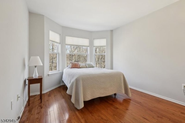 bedroom featuring baseboards and wood-type flooring