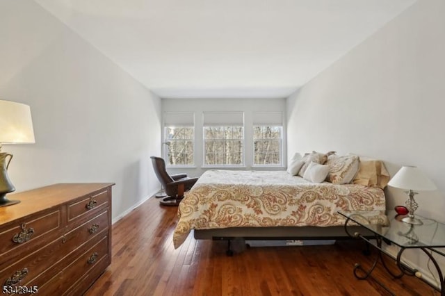 bedroom with dark wood-style floors