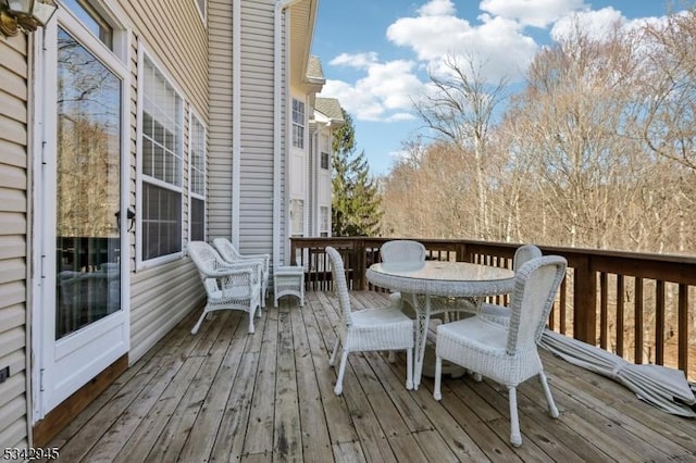 wooden deck featuring outdoor dining area