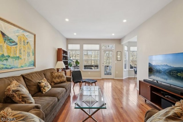 living area featuring recessed lighting, baseboards, and hardwood / wood-style flooring