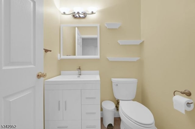 half bath featuring toilet and vanity