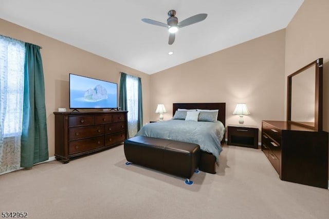 bedroom with lofted ceiling, light colored carpet, and ceiling fan