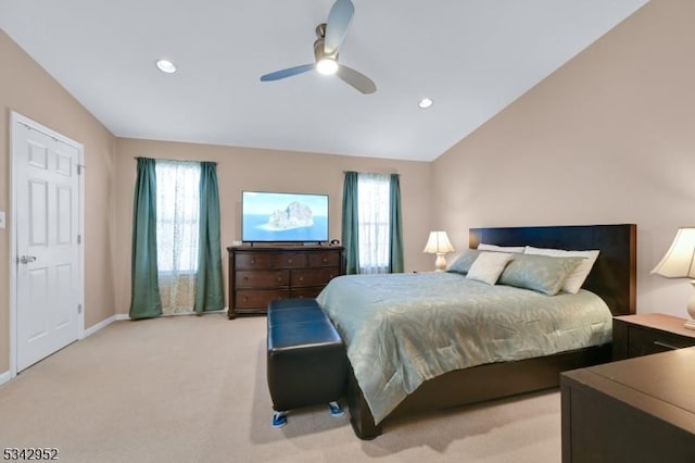 bedroom with multiple windows, light carpet, ceiling fan, and vaulted ceiling